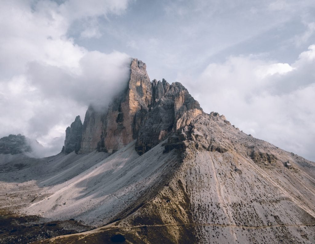 Breathtaking mountain landscape featuring towering peaks and misty clouds.